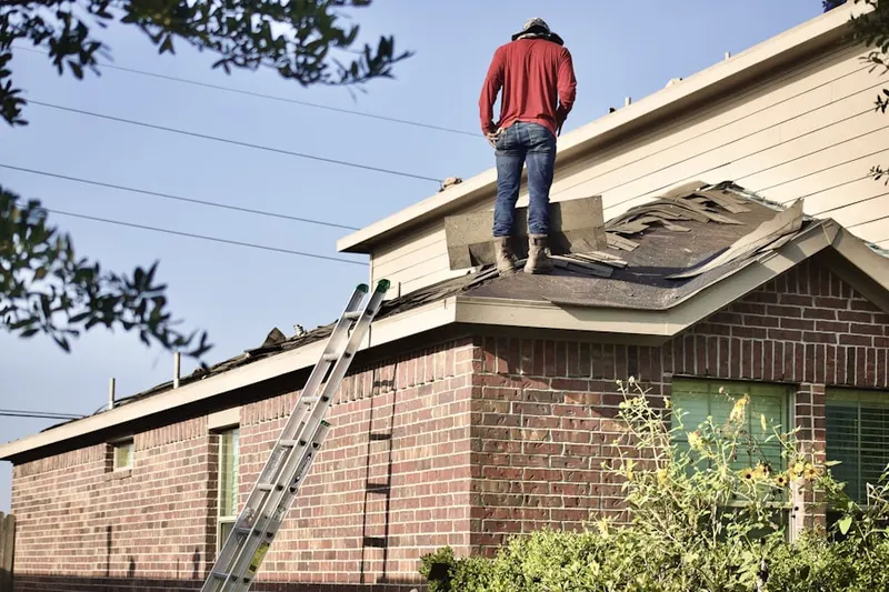 Professional roofer working on a residential roof in Southwest Lakes